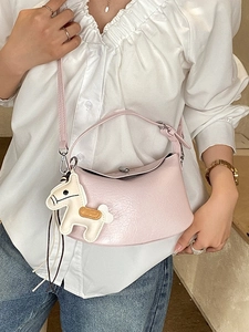 Chic light pink half-moon shoulder bag with horse charm and adjustable strap for women