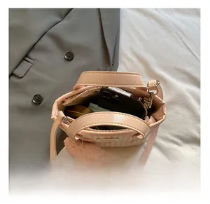 Pink checkered bucket bag interior showcasing spacious storage for phone and cosmetics
