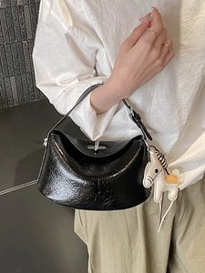 Minimalist black glossy leather handbag with horse charm and silver metal clasp