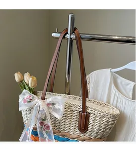 Detail of woven straw bag showing floral lace bow and colorful striped base accents