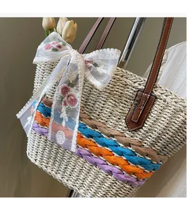 Detail of woven straw bag with colorful stripes, lace bow and floral embroidery