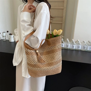 Large straw tote bag with tassel charm and woven straps for beach vacation