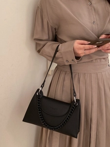 Minimalist black lychee pattern underarm bag with decorative chain and slim shoulder strap