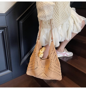 Detailed close-up of beige woven tote bag featuring hollow diamond patterns and tulips