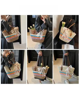 Straw woven tote bag with colorful bohemian stripes and white lace bow detail