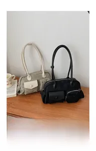 Detail shot of canvas and nylon shoulder bags with decorative exterior pockets on wood