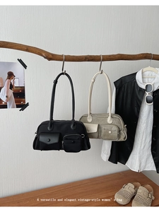 Close-up of vintage shoulder bag with functional flap pockets and metallic button details