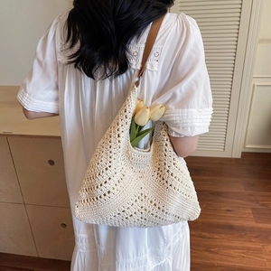 Beige crochet woven tote bag with hollow knit texture and brown shoulder strap