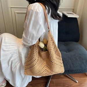 Knitted hollow tote bag in khaki with brown leather straps for a bohemian aesthetic