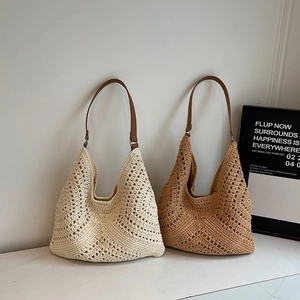 Hollow out woven knit tote bag in cream and tan colors with brown leather shoulder strap