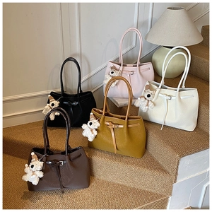 Collection of large woven tote bags in five colors with cute plush bear charms on stairs