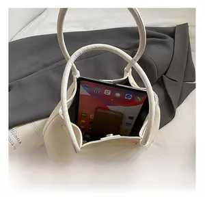 Macro shot of white woven tote bag interior showing capacity for tablet and phone