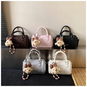 Detailed view of mini Boston bags in multiple colors with cute bear charms and bead straps