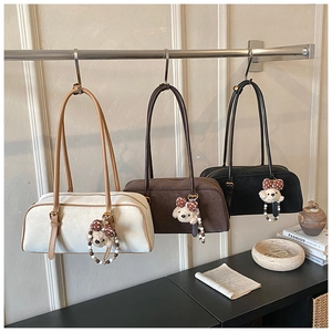 Three minimalist baguette bags in cream, brown and black with cute bear charms