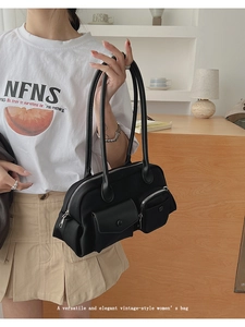 Detail of vintage black nylon underarm bag with multiple zip pockets for women