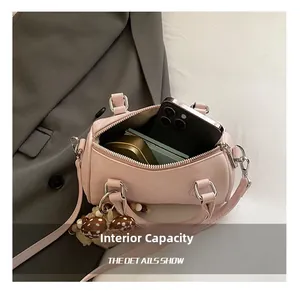 Pink boston bag interior showing storage space for phone and cosmetics with silver hardware