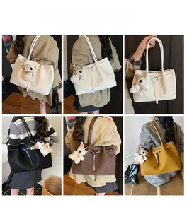 Detailed views of woven tote bag in four colors with charm and buckle accents