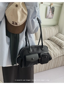 Detail shot of black vintage nylon shoulder bag with functional dual front utility pockets