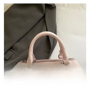 Pink Boston style handbag with polka dot bow charm and metallic D-ring details