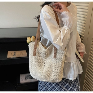 Fashionable woven straw tote bag with brown leather straps and V-pattern texture