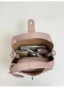 Detail view of pink litchi grain bucket bag interior with zipper pocket and large capacity