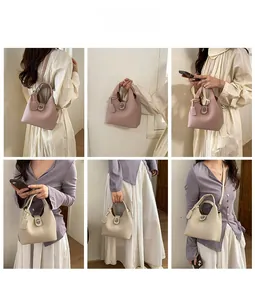 Detail view of lychee grain leather bucket bags with silver metal lock in pink and white