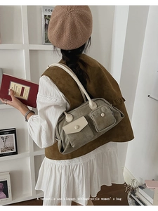 Detail of vintage canvas green shoulder bag with white leather flaps and pockets