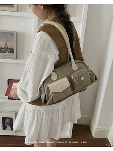 Detail of vintage canvas shoulder bag with khaki fabric and beige leather pockets