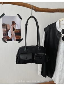 Detail of vintage black shoulder bag with multi-pockets and premium leather stitching