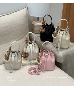 Detailed view of bucket bags with lychee grain leather and cute horse charms