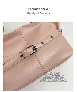 Detail of soft pink tote bag showing smooth leather texture and metal buckle hardware