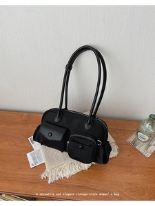 Detailed macro view of the black vintage shoulder bag with multiple functional pockets