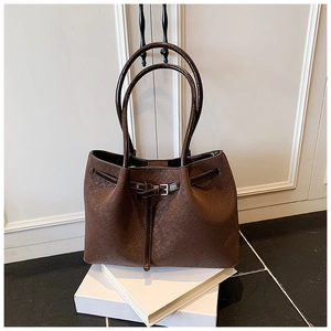 Detail of the brown woven texture and metal buckle on this large capacity tote bag