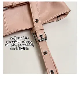Detail view of pink leather tote bag showing adjustable shoulder strap and silver buckle