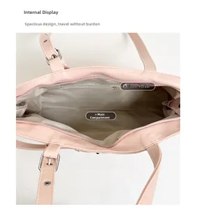 Detail view of pink tote bag interior featuring grey herringbone lining and zipper pocket
