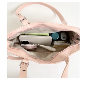 Interior view of large pink tote bag showing spacious capacity for phone and cosmetics
