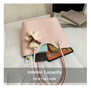 Detail view of pink leather tote bag showing large interior capacity for tablet and cosmetics