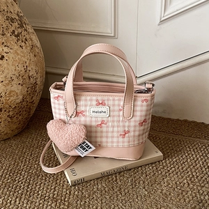 Chic bucket handbag with pink checkered pattern, red bow details and heart pendant
