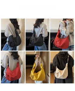 Detail showing side drawstring of large capacity slouchy shoulder bag in four colors