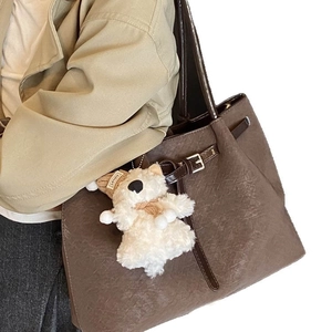Vintage brown woven tote bag with large capacity and cute plush bear charm for daily commute