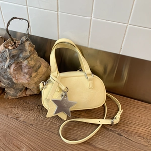 Pale yellow wrinkled leather mini Boston bag with adjustable strap and star pendant