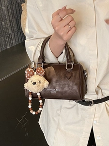 Brown Boston style shoulder bag with natural texture and cute puppy charm for women