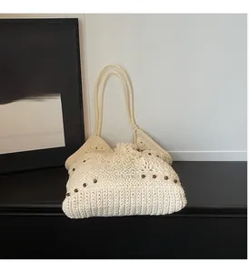 Detailed close-up of woven cotton shoulder bag with wooden beads and crochet craftsmanship
