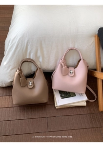 Macro detail of lychee grain leather bucket bags with silver turn-lock and retro vibe