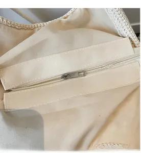 Close-up of smooth metal zipper and premium interior lining of woven beach bag