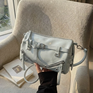 Light blue bowling bag with motorcycle style buckles and silver rivets for women