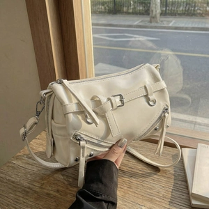 Creamy white bowling bag in glossy faux leather with silver hardware and shoulder strap