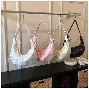 Detailed display of four floral pleated dumpling bags in white, pink, green, and black