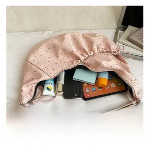 Pink star-patterned dumpling bag interior showing capacity for tablets and phones