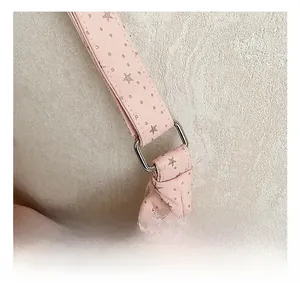 Close-up of pink shoulder bag with silver star patterns and premium square metal buckle